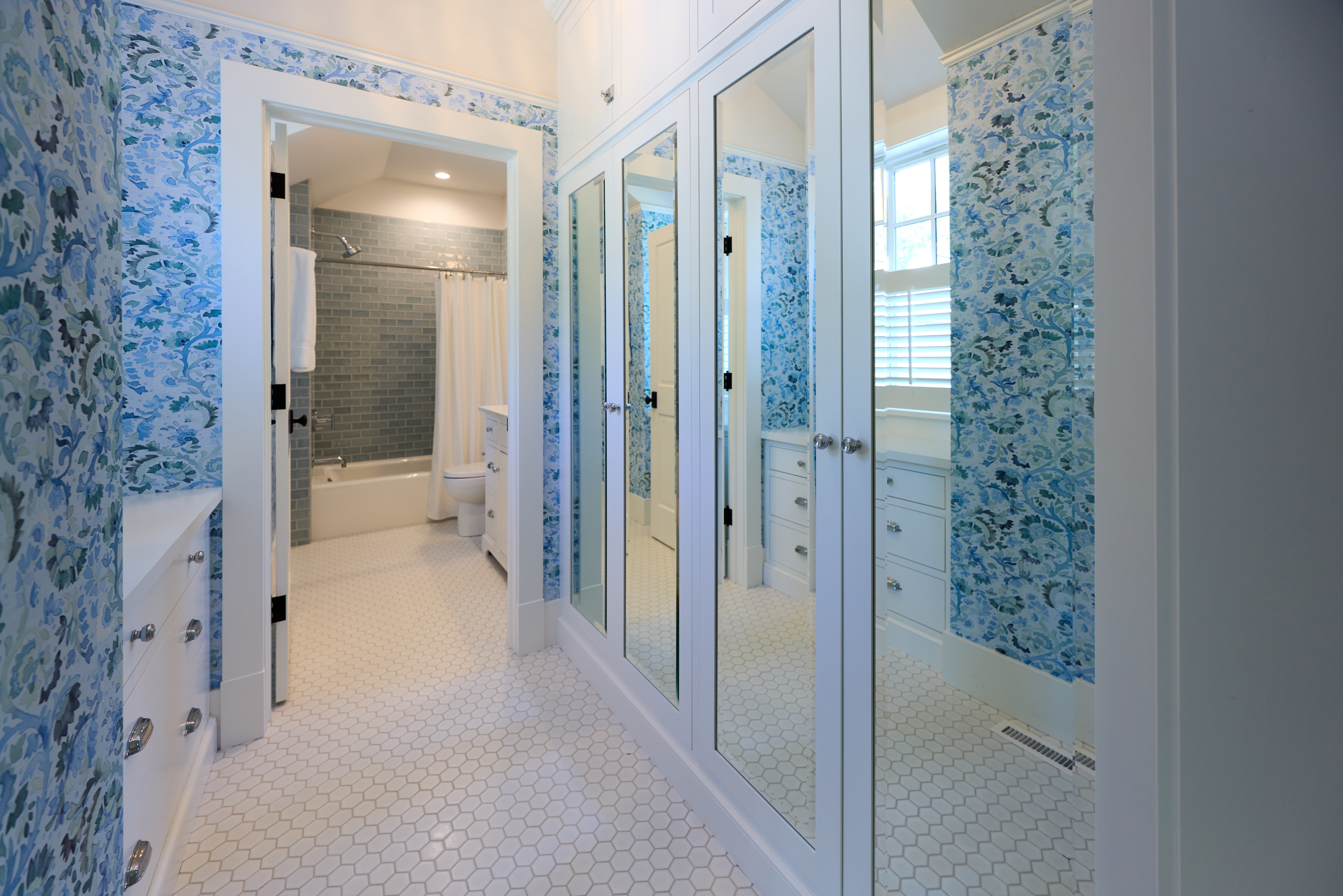 small bathroom with added blue and yellow colors with natural wood and plants 