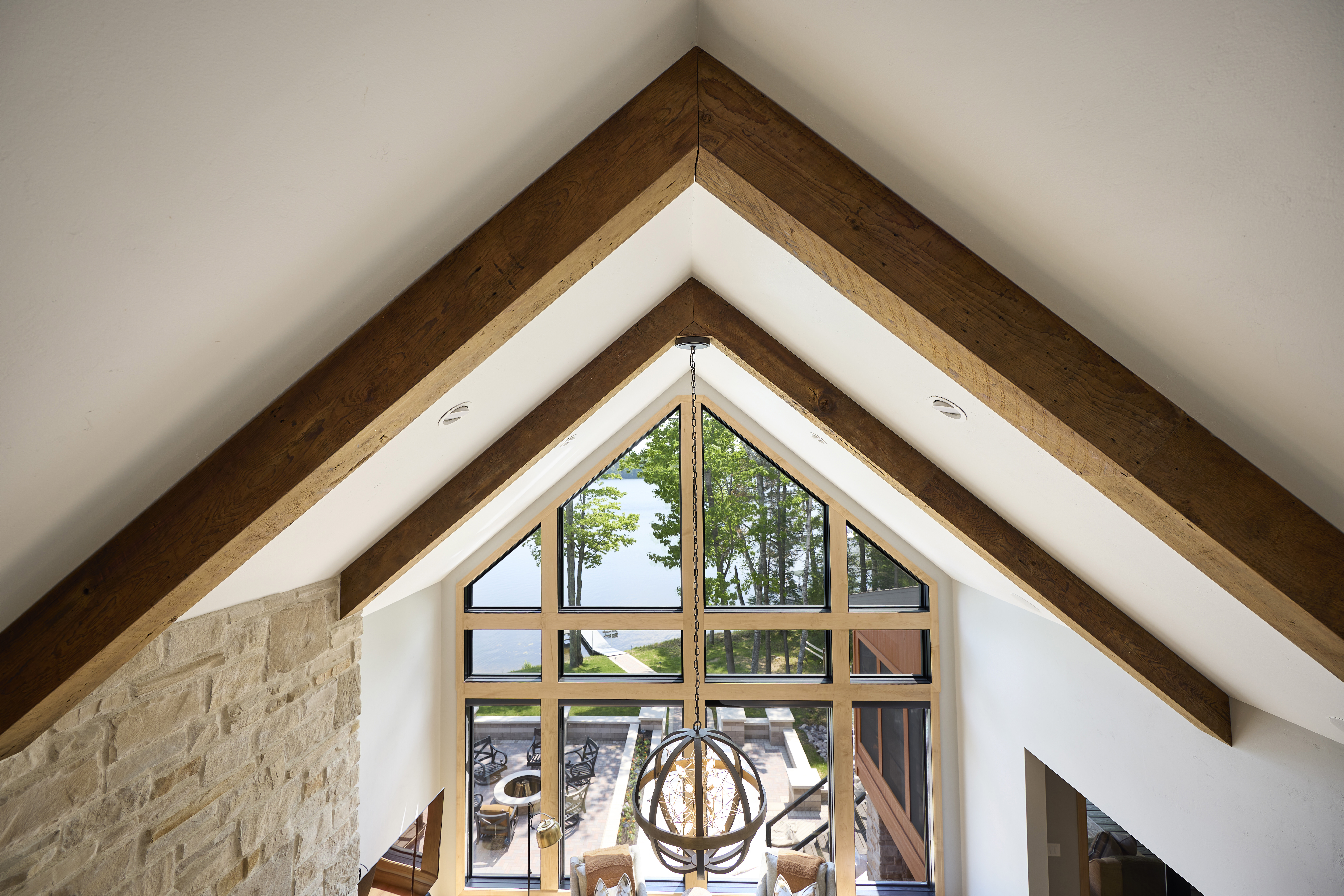 dinning room with warm wood tones and lofted ceiling 
