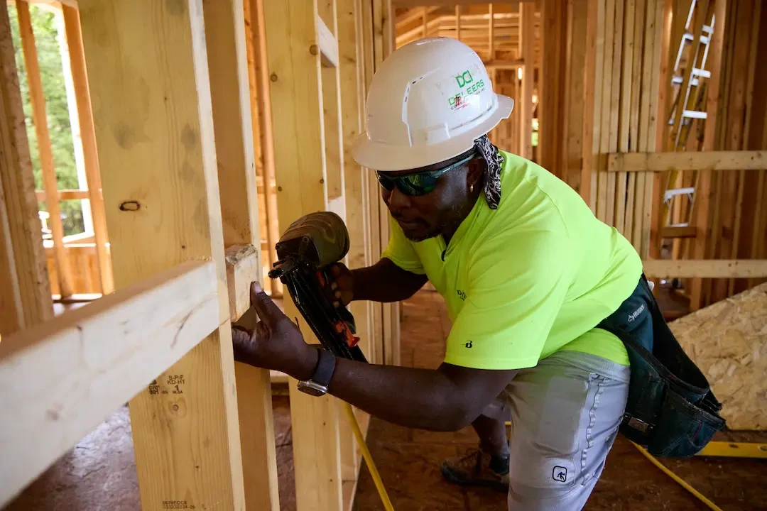 A person standing in the commercial space under construction 