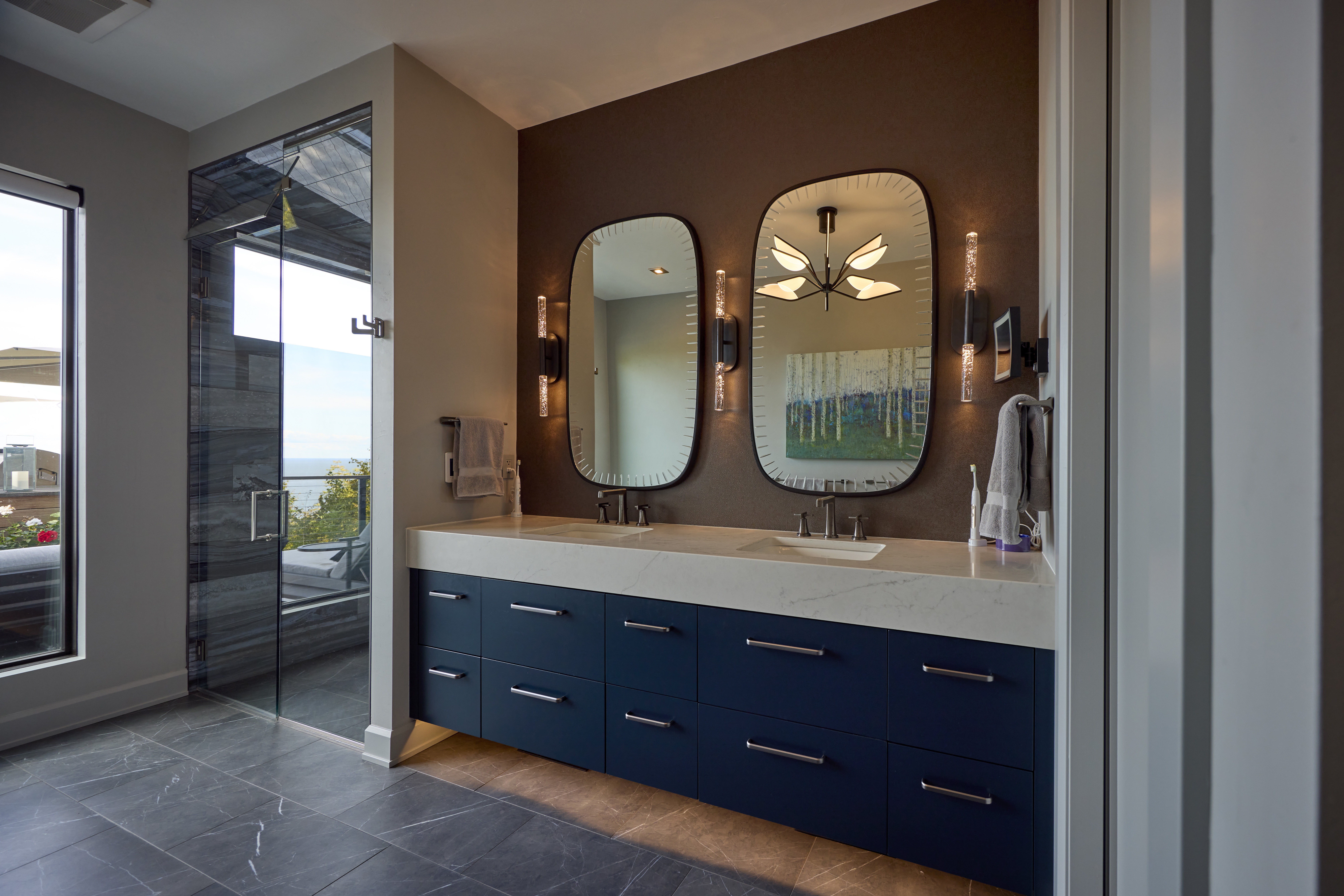 small bathrooms with brick tile and a big mirror, plants on the shelves