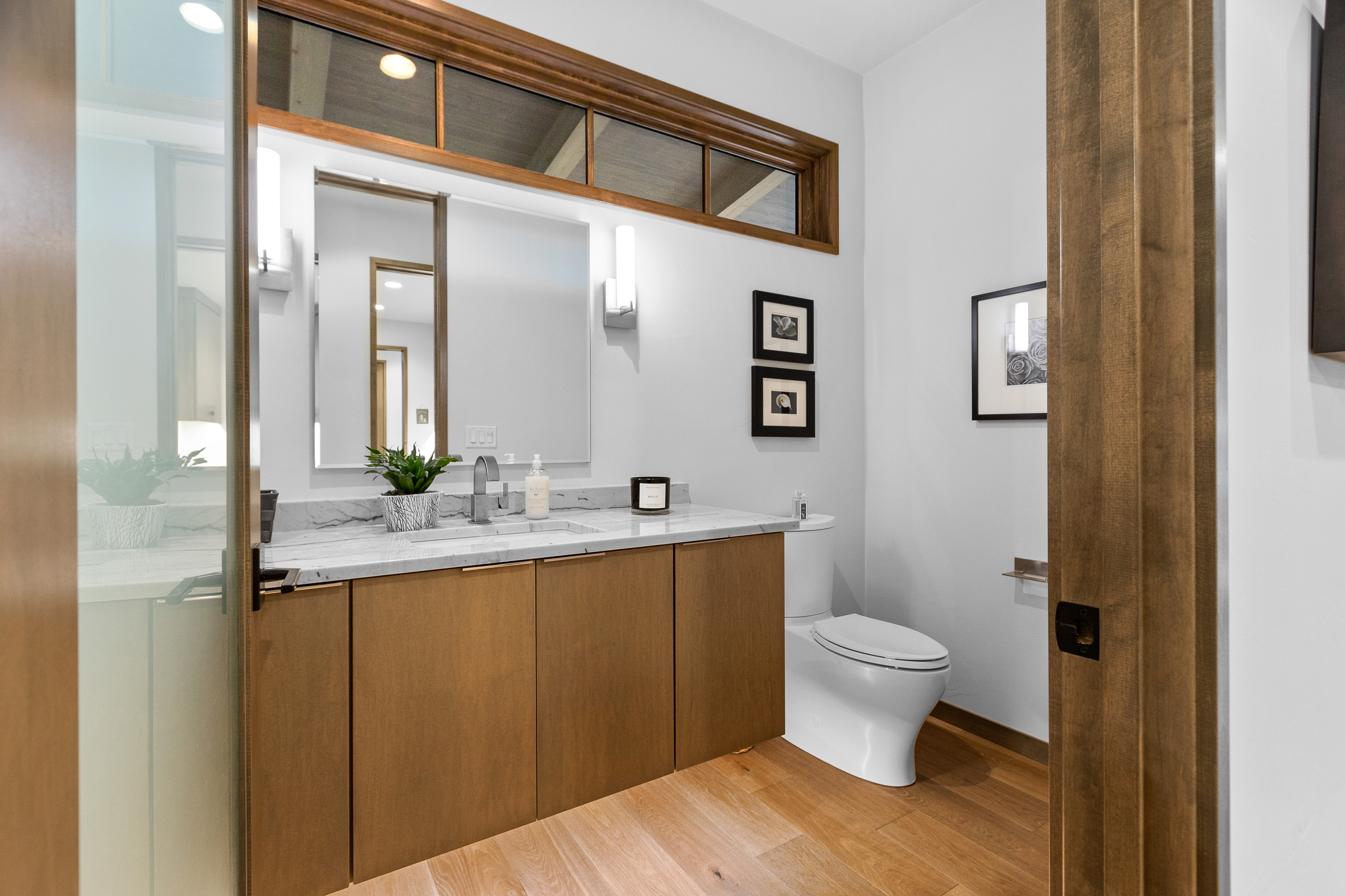 small bathroom with added storage space hang up on the door 